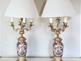 pair of antique lamps on a table with white lampshads