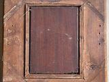 a picture of a wooden picture frame hanging on a wall