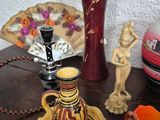 a table with a vase, candle holder, and other items on it