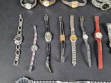 a lot of watches and bracelets that are on the table