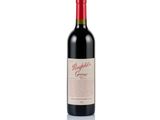 a bottle of red wine sitting on top of a white surface