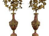 pair of antique bronze and red vases with flowers on stands