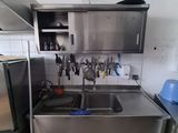 a kitchen with a sink and a refrigerator in it
