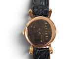 an image of a close up of a wrist watch on a white surface