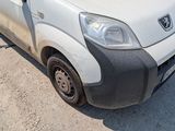 a small white van that is parked in a lot