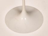 a glass of wine sitting on a white table