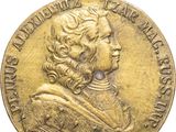 une image représentant une médaille d'or sur laquelle figure le portrait d'un homme