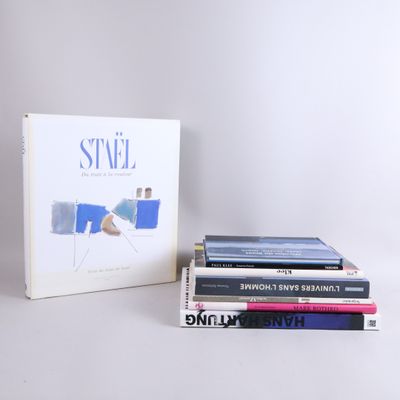 several books are stacked on top of each other on a table
