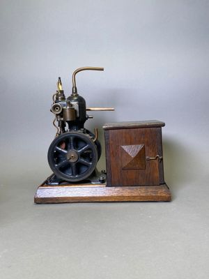 a small model of a steam engine on a wooden stand