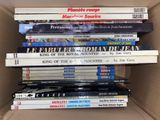 many books stacked on top of each other in a box