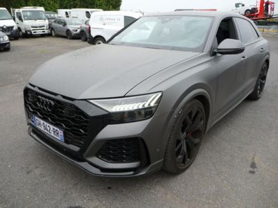 a grey audi suv parked in a parking lot next to other cars