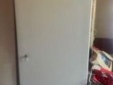 a refrigerator that is sitting in the corner of a room