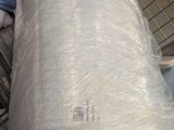 a large roll of plastic wrapped up in a shopping cart