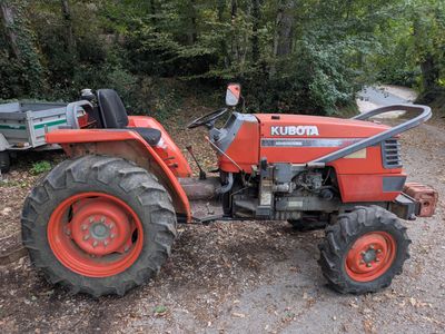 a red tractor that is parked on the side of the road