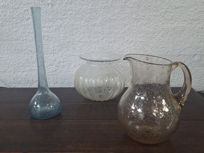three vases sitting on a table next to each other