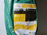 a bag of soil sitting on the floor next to a wall