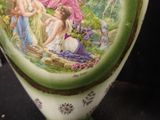 a vase with a picture of a woman and two other women on it