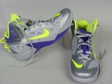 pair of grey and yellow shoes with purple accents on a white surface