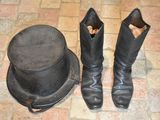 a hat and boots on the floor next to a top hat