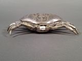 a silver crab that is sitting on a table