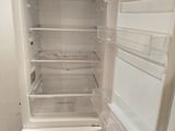 a white refrigerator with its door open in a room