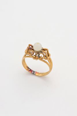 an image of a gold ring with a pearl in the center
