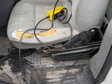 an image of a dirty car with a power cord in it