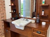 a bathroom with a sink and a mirror on the wall
