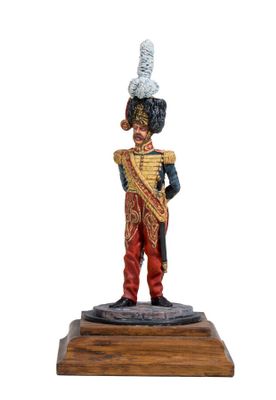 a statue of a soldier with a drum on a wooden base