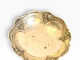 a silver plate with a flower design on it