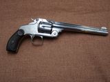 an old revolver on a brown background with a black handle