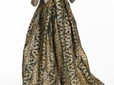 the back of a dress with a gold and green pattern on it