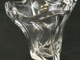 a glass vase with a flower inside of it