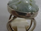 a picture of a ring with a green stone in it