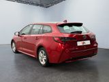 the rear end of a red toyota corollant in a showroom