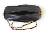 a close up of a black purse on a white background