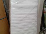 un matelas qui se trouve au milieu d'une pile de cartons