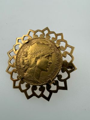 a close up of a gold coin on a white surface