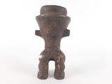 wooden statue of a man with a hat on top of his head