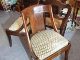 a chair and a table in a room with a dresser