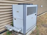 an air conditioner sitting outside of a building next to a building