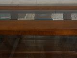 a glass display case in the corner of a room