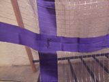 a close up of a chair with a purple ribbon on it