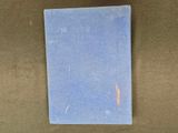 the blue book is sitting on a brown surface