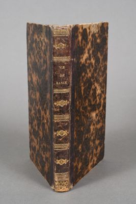 an old book sitting on top of a table next to a gray background