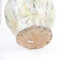 a vase that is sitting on a white surface