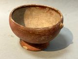 a brown bowl sitting on top of a white table