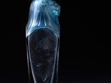 a clear glass bottle with a blue bow on it