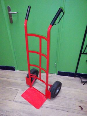 a red hand truck that is sitting on the floor