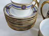 a lot of cups and saucers sitting on a table
